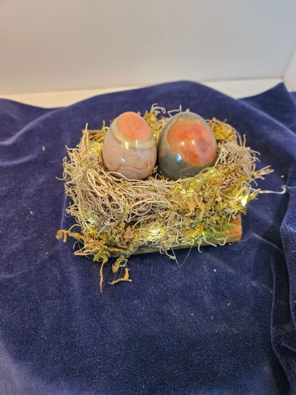 Two large polychrome eggs in a lighted nest