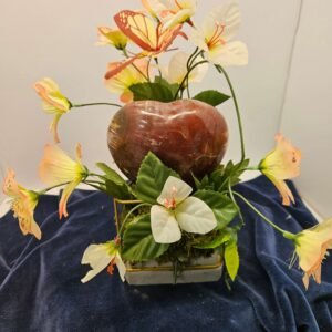 Five-inch rose quartz egg with flowers on a stand