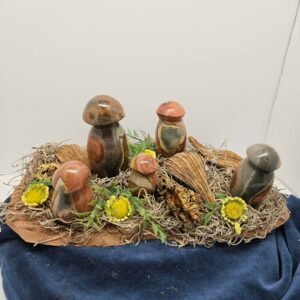 Five polychrome jasper mushrooms with flowers on wood