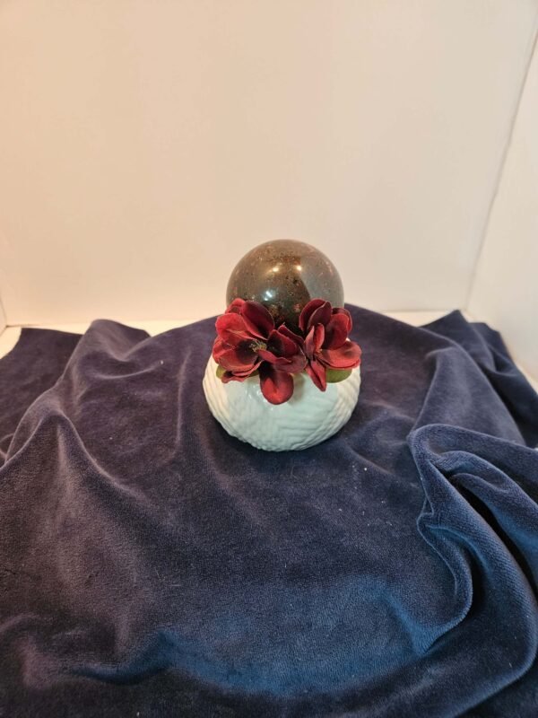 Three-inch mahogany obsidian sphere with flowers on a ceramic stand