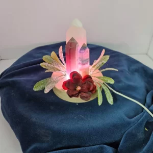 Three-inch rose quartz tower and two fluorite towers with flowers on a lighted stand