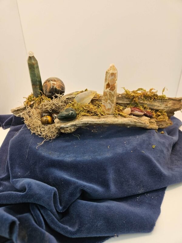 Tower, sphere and leaf on driftwood