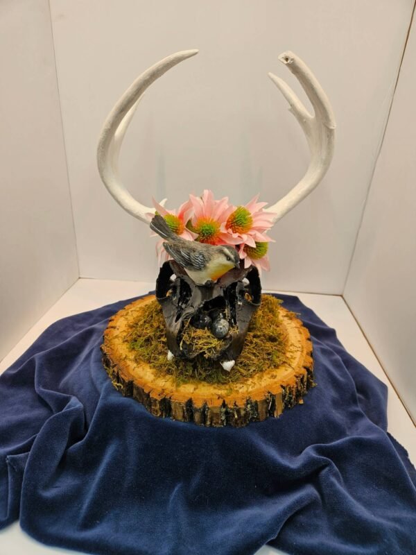 painted deer skull with antlers and bird with eggs in nest