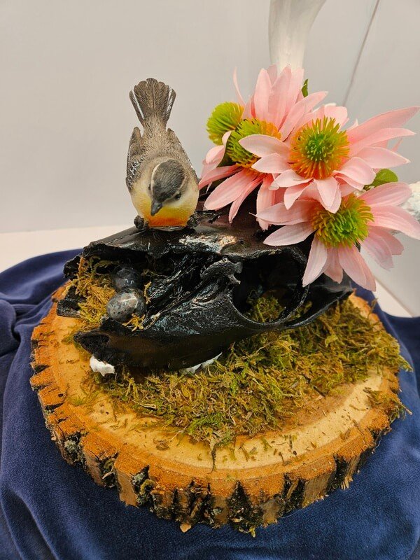 painted deer skull with antlers and bird with eggs in nest