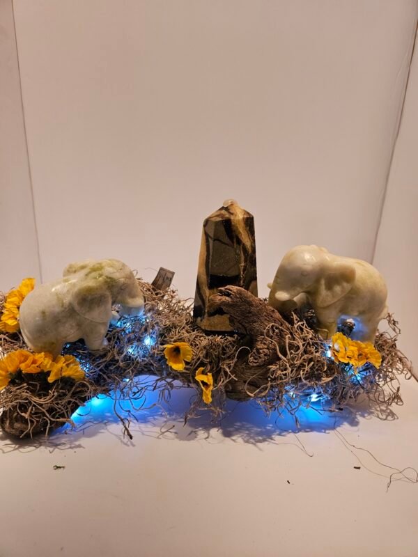 Two green jade elephants and septarian tower with fairy lights.