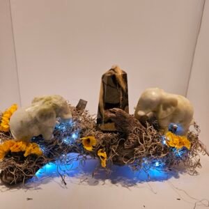 Jade elephants and ceptarian tower on driftwood with fairy lights
