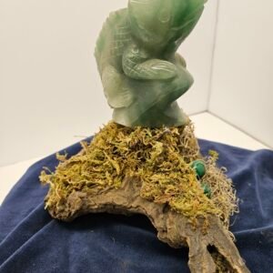 Green adventurene lizard on driftwood with imitation malikite eggs