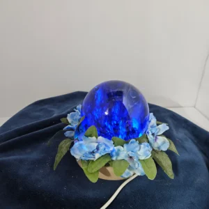 large lighted blue glass sphere