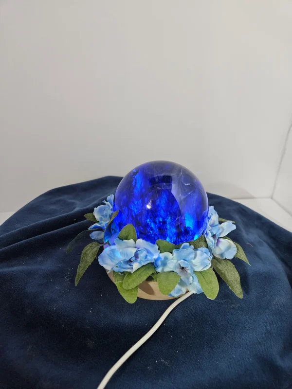 large lighted blue glass sphere