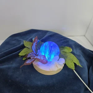 small lighted blue glass sphere