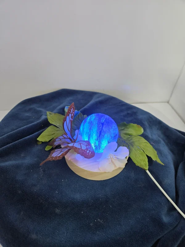 small lighted blue glass sphere